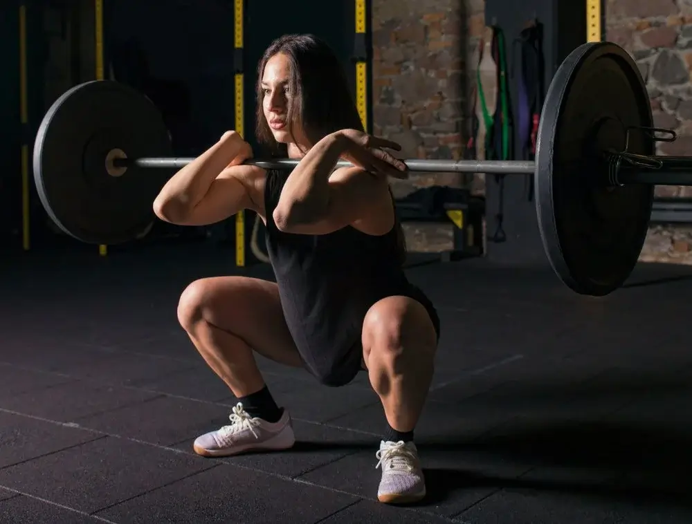 Member performing a squat with proper form