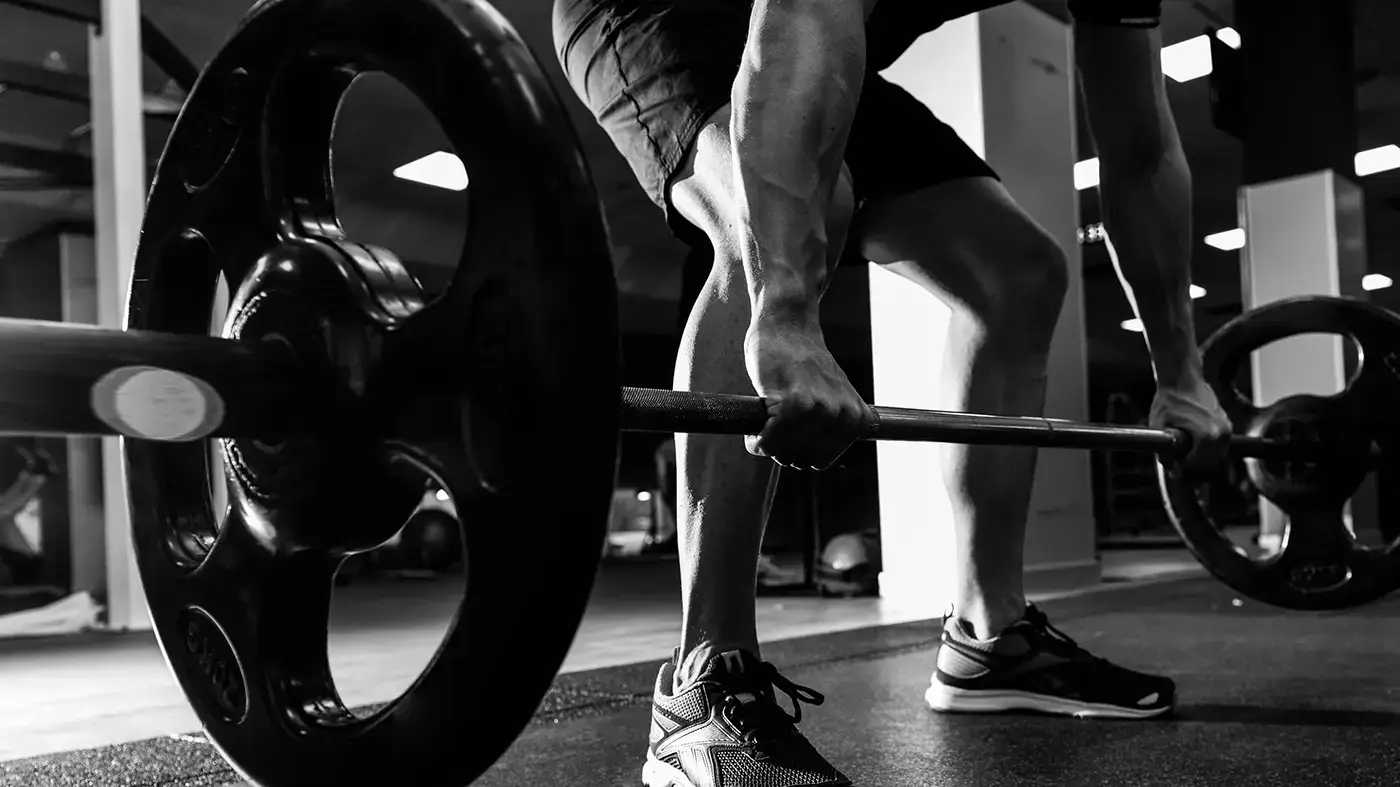 Athlete performing a heavy deadlift at a workshop